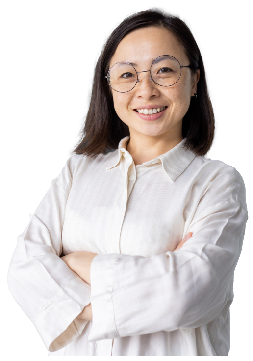 BDD-for-scrum-teams-Hero A person in a white blouse and glasses smiles and poses for the camera with arms crossed