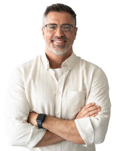 Hero-Conflict-Management-Skills A man wearing glasses and a white button up crosses his arms and smiles against a white background